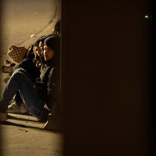 FILE - A group of migrants wait to be processed between two border walls separating Mexico and the United States after crossing illegally before dawn, Jan. 21, 2025, in San Diego. (AP Photo/Gregory Bull, File)