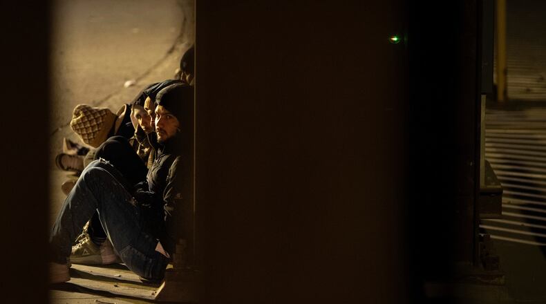 FILE - A group of migrants wait to be processed between two border walls separating Mexico and the United States after crossing illegally before dawn, Jan. 21, 2025, in San Diego. (AP Photo/Gregory Bull, File)