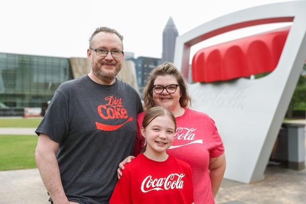 John and Kristin Carder, with daughter Ella, 10, came from Dallas, Ga., to visit the popular World of Coca-Cola on Saturday, July 19, 2025, in Atlanta. (Abbey Cutrer/AJC)