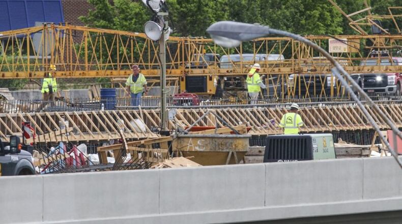Work continued May 1 on the new I-85 bridge in Buckhead. Since a fire led to the collapse of a segment of I-85 in Buckhead on March 30, the Georgia Department of Transportation has scrambled to reopen the vital stretch of highway into the heart of Atlanta. Contractor C.W. Matthews is rebuilding 350 feet of northbound and 350 feet of southbound lanes on I-85. JOHN SPINK/JSPINK@AJC.COM