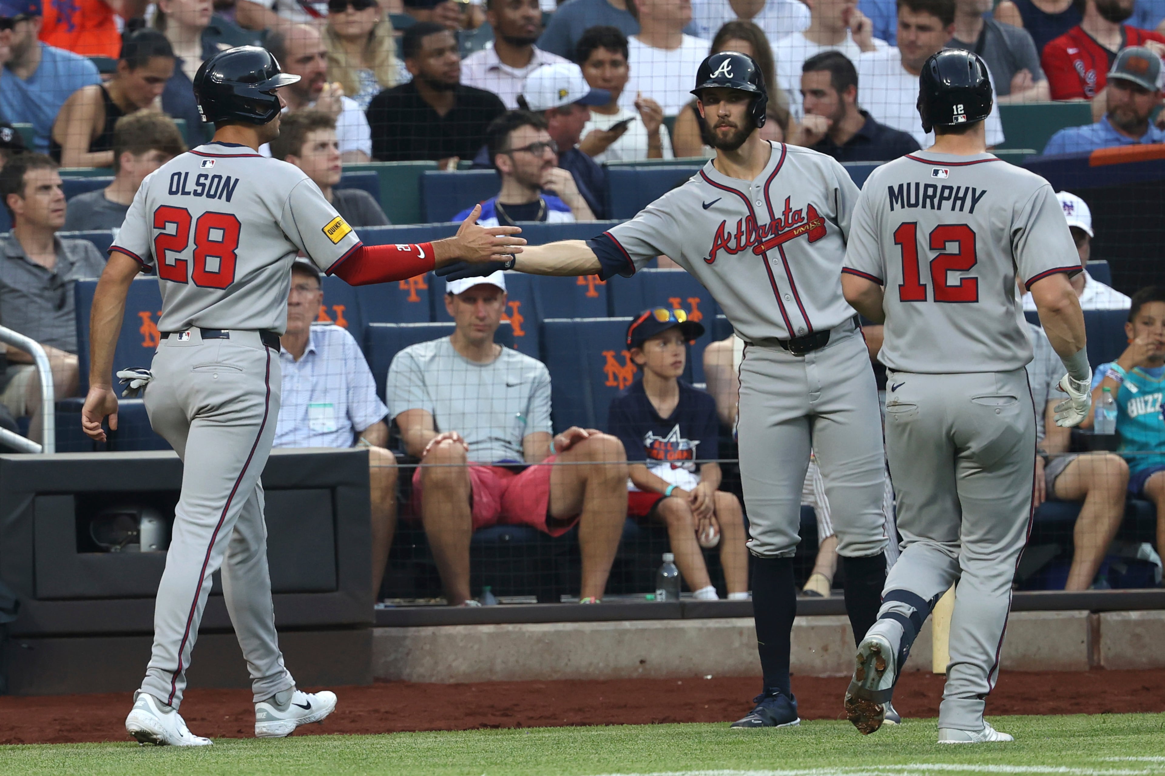 Braves first baseman Matt Olson (from left) celebrates with Eli White after scoring on a sacrifice fly out by Sean Murphy during the third inning of a game against the New York Mets on Monday, June 23, 2025, in New York. (Pamela Smith/AP)