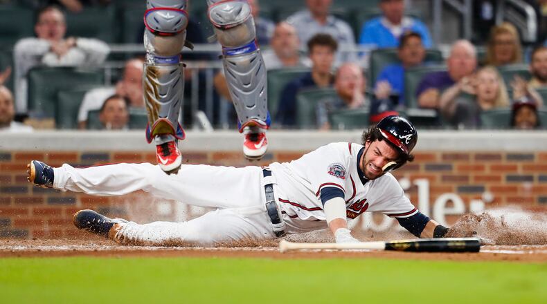 Atlanta Braves Dansby Swanson slides in to score a run in the second inning of the second game of a baseball doubleheader against the Texas Rangers, Wednesday, Sept. 6, 2017, in Atlanta. (AP Photo/Todd Kirkland)