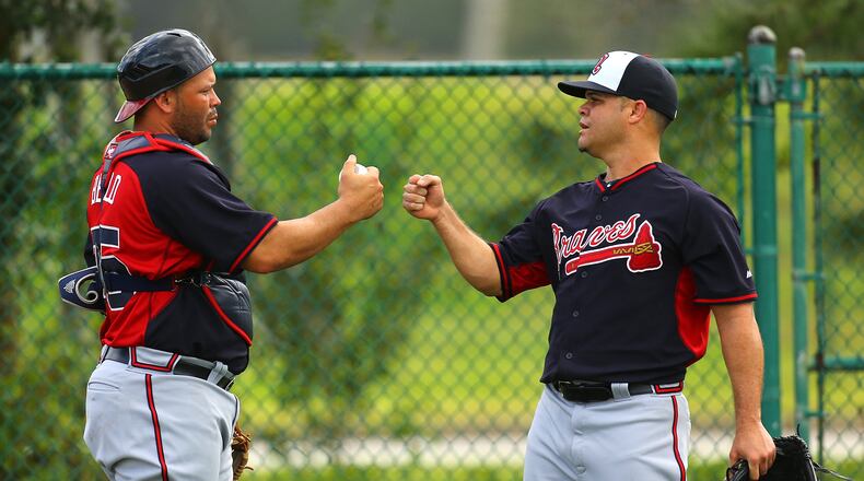 Wandy Rodriguez, shown bumping fists with catcher Yenier Bello after a spring-training workout, was released by te Braves on Friday. (Curtis Compton / ccompton@ajc.com)