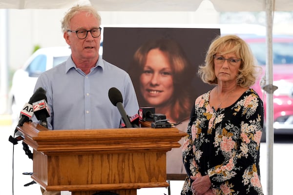 Mike Robirds, left, speaks as his sister, Terri Osborne, right, listens outside Riverbend Maximum Security Institution after the execution of Oscar Smith Thursday, May 22, 2025, in Nashville, Tenn. Robirds and Osborne are siblings of Judy Robirds, shown in the photograph between them, who was murdered along with her sons by Oscar Smith in 1989. (AP Photo/Mark Humphrey)