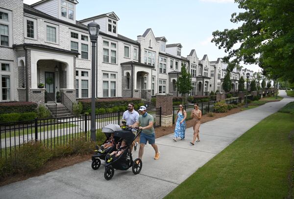 Residents stroll down a sidewalk in Brookhaven on Friday, June 26, 2026. (Hyosub Shin/AJC)