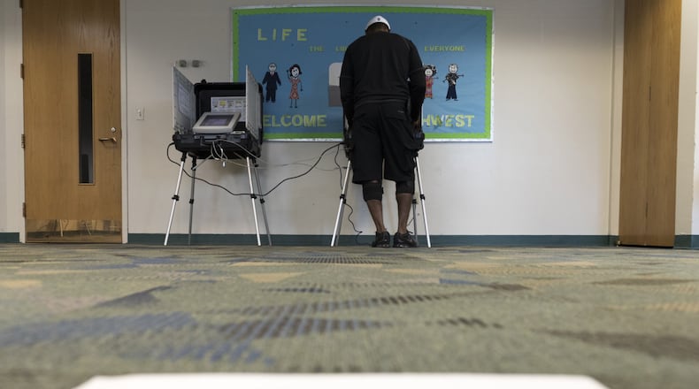 Darryl W. Smith, 51, votes at a voting station at the Southwest Branch Library in Atlanta, Georgia. South Fulton residents and others will vote in an April 18 runoff. (DAVID BARNES / DAVID.BARNES@AJC.COM)