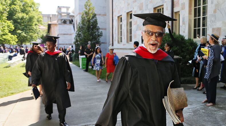 Hurl Taylor, 77, walks out with a big smile during the recessional on May 9. Decades after graduating from Emory Law, he received a master’s degree from Candler School of Theology to support his prison ministry. BOB ANDRES / BANDRES@AJC.COM