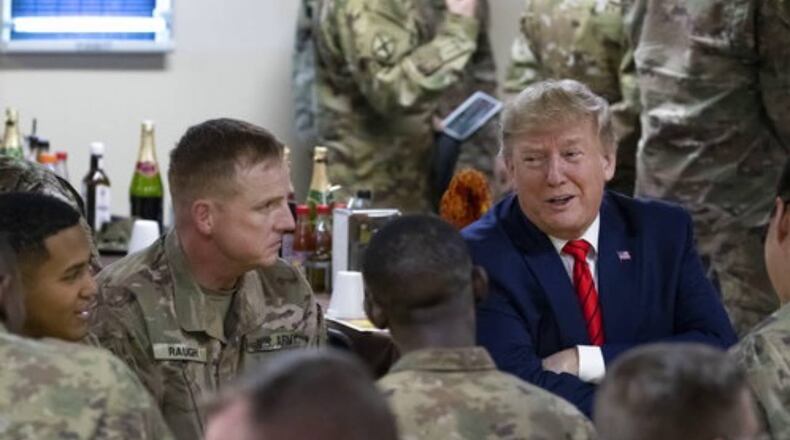 President Donald Trump talks with troops Thursday during his surprise visit to Afghanistan.