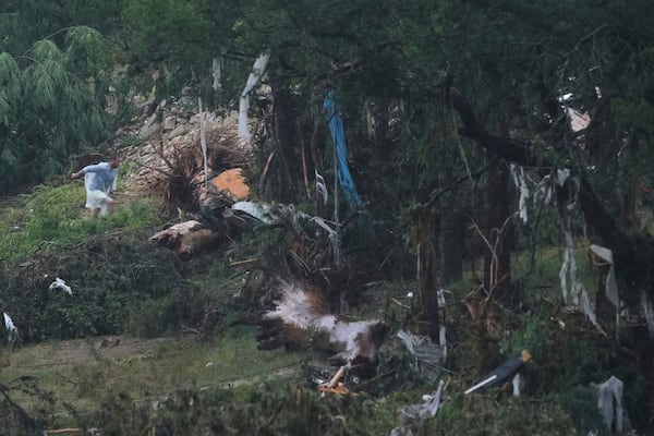 A man surveys damage left by a raging Guadalupe River, Friday, July 4, 2025, in Kerrville, Texas. (AP Photo/Eric Gay)
