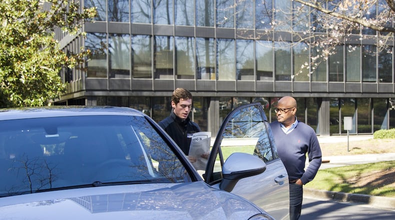 Todd C. Duncan, a senior editor at The Atlanta Journal-Constitution, has a 2018 Porsche Cayenne GTS delivered to him at The Atlanta Journal-Constitution office in Dunwoody, Georgia, on Wednesday, March 7, 2018. This car is part of Porsche’s car subscription service, Porsche Passport, where you can drive Porsche models via a monthly subscription. (REANN HUBER/REANN.HUBER@AJC.COM)