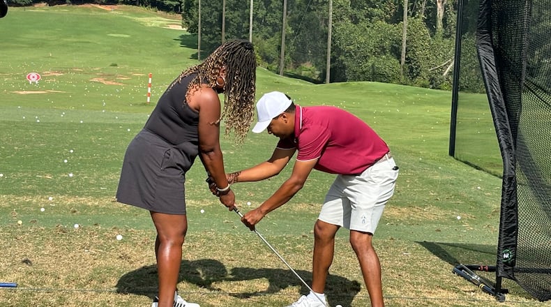 Morehouse golf coach Edgar Evans, a PGA professional, gave quick lessons on the practice tee. Here he's working with Courtney Johnson at Eastside Golf's Community Golf Day, Aug. 3, 2024. (Photo by Stan Awtrey)