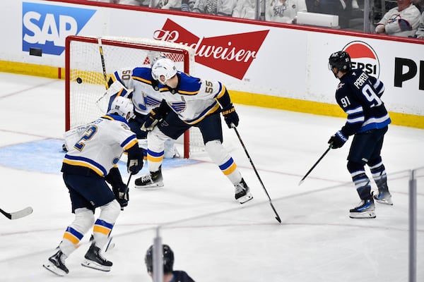 Winnipeg Jets' Cole Perfetti (91) scores against St. Louis Blues goaltender Jordan Binnington (50) during the second period of Game 7 in an NHL hockey first-round playoff series in Winnipeg, Manitoba, Sunday, May 4, 2025. (Fred Greenslade/The Canadian Press via AP)