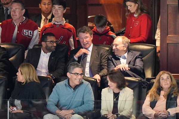FBI director is Kash Patel, left, tallking with former NHL player Wayne Gretzky, center, and NHL Commisioner Gary Bettman, right, during the first period of an NHL hockey game between the Washington Capitals and Chicago Blackhawks, Friday, April 4, 2025, in Washington. (AP Photo/Mark Schiefelbein)