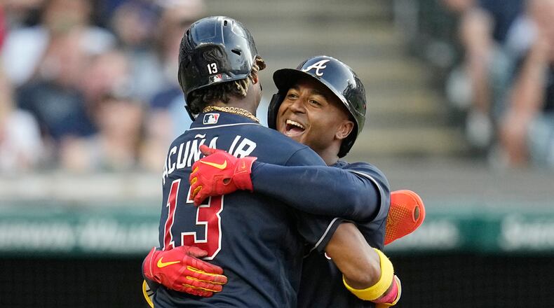 Atlanta Braves' Ozzie Albies, right, celebrates his two-run home run against the Cleveland Guardians with Ronald Acuna Jr. (13) during the fifth inning of a baseball game Tuesday, July 4, 2023, in Cleveland. (AP Photo/Sue Ogrocki)
