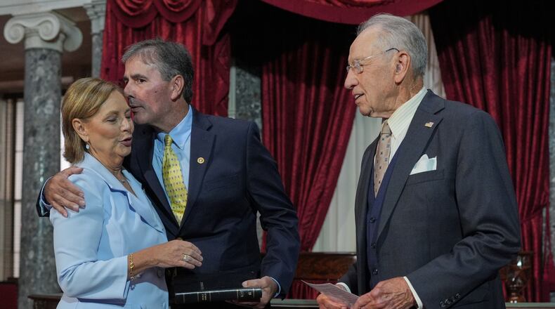 Sen. Darline Graham, R-S.C., sister of Sen. Lindsey Graham, R-S.C., is ceremonially sworn-in by President Pro Tempore of the Senate, Chuck Grassley, R-Iowa, in the Old Senate Chamber at the Capitol in Washington, Tuesday, July 14, 2026, as her husband Larry Nordone holds the Bible and gives her a kiss. (AP Photo/J. Scott Applewhite)