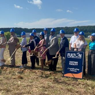 Fulton County officials gather for a groundbreaking ceremony for a customs facility at Fulton County Executive Airport on Thursday, July 9, 2026. (Carson Bonner/AJC)