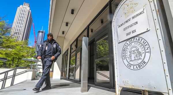 A security guard walks past the unemployment certification drop box in front of the Georgia Department of Labor. Jobless claims have skyrocketed since the COVID-19 pandemic  shut down businesses across the state and country, with Georgia’s claims filed in a three-week period surpassing figures from the peak of the Great Recession. JOHN SPINK / JSPINK@AJC.COM