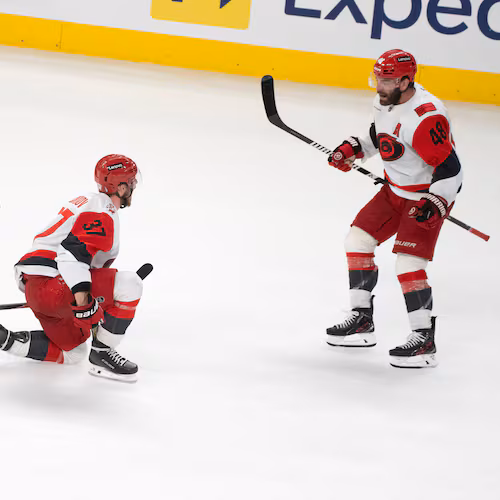 Carolina Hurricanes' Andrei Svechnikov (37) celebrates with teammates Jaccob Slavin (74), Jalen Chatfield (5) and Jordan Martinook (48) after a goal by teammate Sebastian Aho (not shown) during overtime of Game 3 of the Eastern Conference finals NHL hockey Stanley Cup playoff series against the Montreal Canadiens in Montreal, Monday, May 25, 2026. (Christinne Muschi/The Canadian Press via AP)