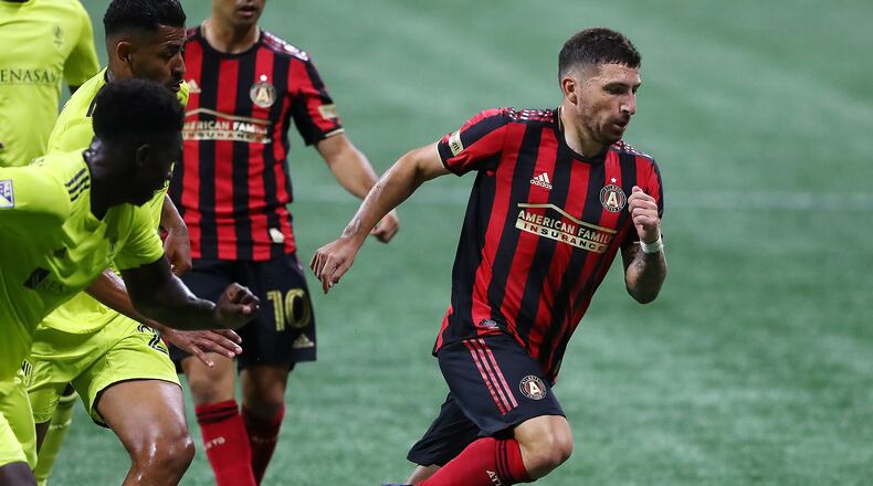 082220 Atlanta: Atlanta United midfielder Eric Remedi breaks away from Nashville SC defenders during their MLS soccer match on Saturday, August 22, 2020 in Atlanta.    Curtis Compton ccompton@ajc.com