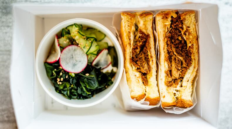 This chicken katsu sando from Momonoki in Midtown is served with cucumber wakame salad. CONTRIBUTED BY HENRI HOLLIS