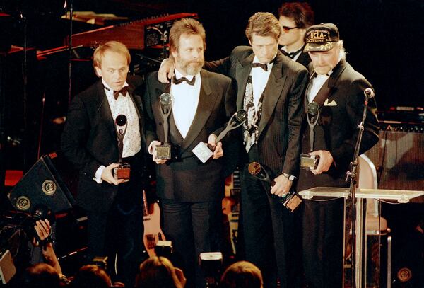 FILE - The Beach Boys, from left, Al Jardine, Carl Wilson, Brian Wilson and Mike Love, hold their trophies after being inducted into the Rock 'n' Roll Hall of Fame in New York, Jan. 21, 1988. (AP Photo/Ron Frehm, File)