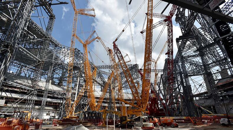 090116 Atlanta: The first seats were installed at Mercedes-Benz Stadium during a ceremony Thursday September 1, 2016. The estimated $1.5 billion dollar stadium is scheduled to be complete in June 2017. The project is using some of the largest crawler cranes in the world to help lift the massive steel beams into place for the retractable roof. BRANT SANDERLIN/BSANDERLIN@AJC.COM