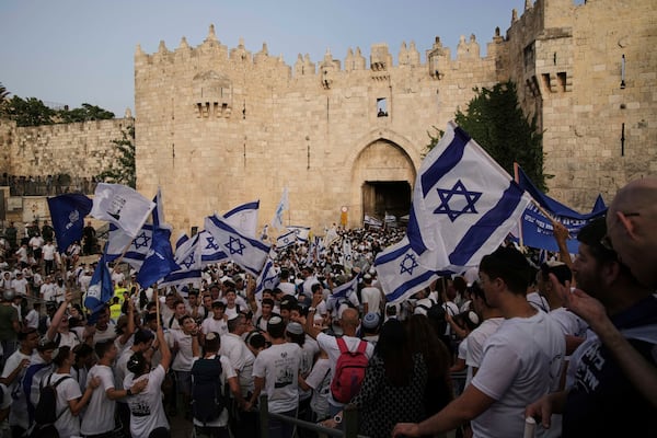 Israelis participate in a march marking Jerusalem Day, an Israeli holiday celebrating the capture of east Jerusalem in the 1967 Mideast war, in Damascus Gate of Jerusalem's Old City, Monday, May 26, 2025. (AP Photo/Leo Correa)