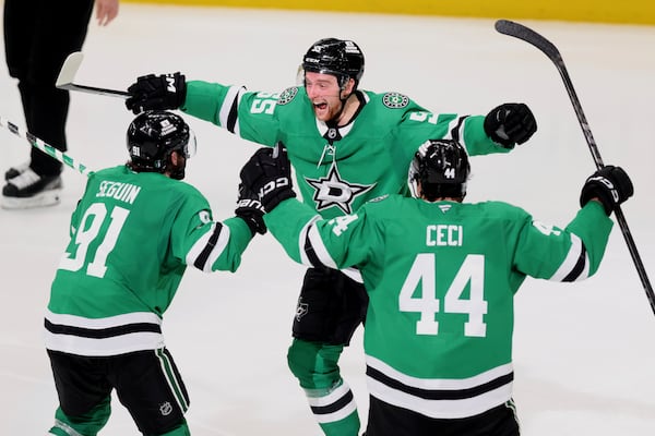 Dallas Stars' Tyler Seguin (91), Thomas Harley (55) and Cody Ceci (44) celebrate after Harley scored in overtime in Game 6 of a second-round NHL hockey playoff series against the Winnipeg Jets in Dallas, Saturday, May 17, 2025. (AP Photo/Gareth Patterson)