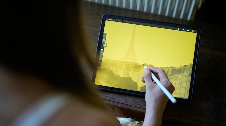 Illustrator Marina Antonova works on a drawing for her series called "Chronicles of a Heating Planet" in Beaumont-les-Valence, southern France, on Sept. 12, 2026. (AP Photo/Laurent Cipriani)