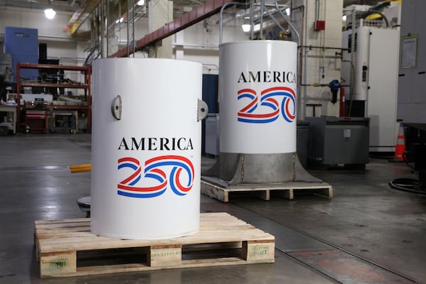 From left, the America250 time capsule and the bell jar that will fit on top of it, shown in the machine shop where they were created at the National Institute of Standards and Technology in Gaithersburg, Md. (Courtesy of NIST)
