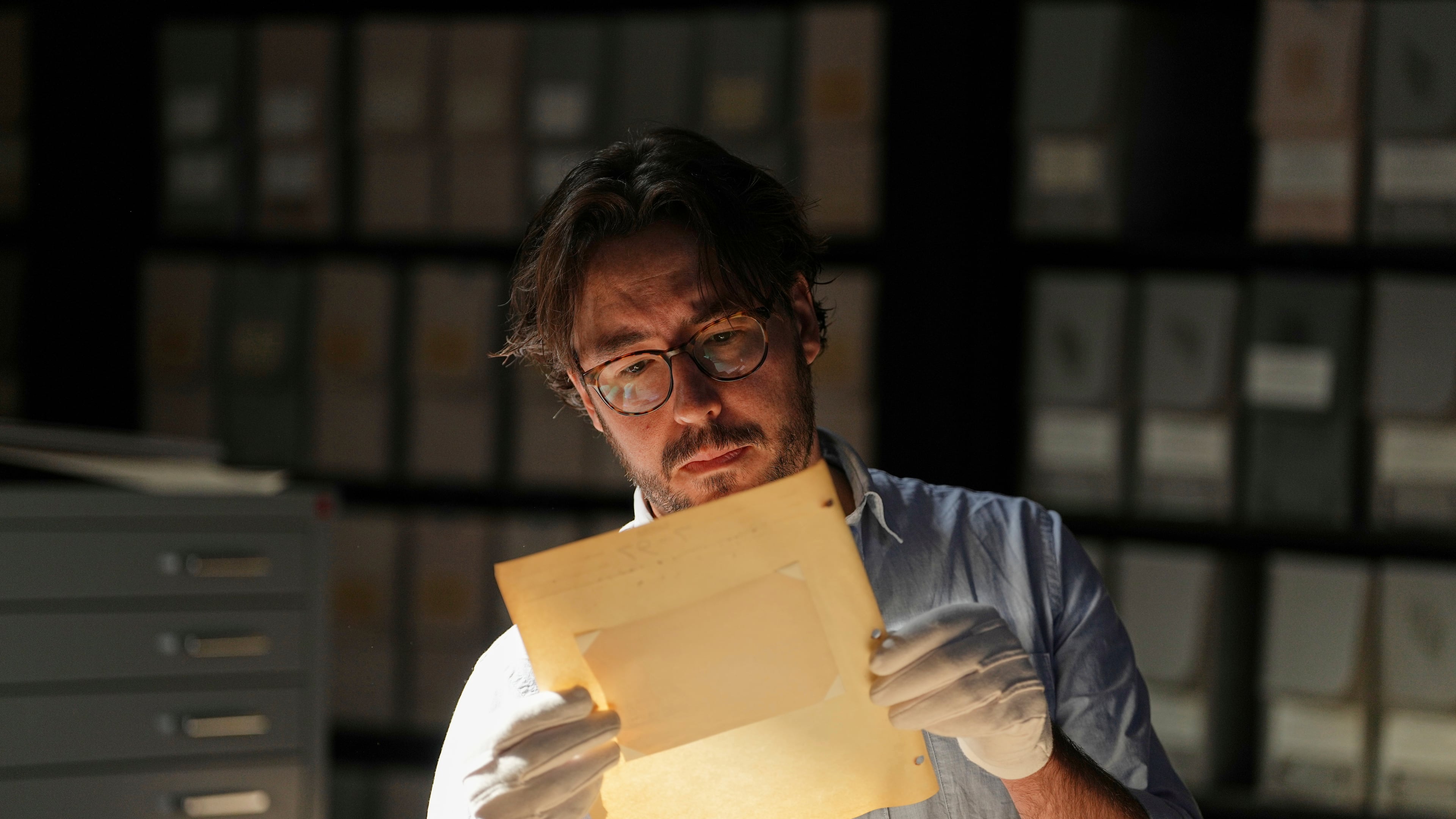 University of Victoria postdoctoral fellow Nathaniel Brunt views an image from a collection of photos of the Yazidi people in their northern Iraq homeland in the 1930s, during an interview at the Penn Museum Archives in Philadelphia, Aug. 27, 2025. (AP Photo/Matt Rourke)