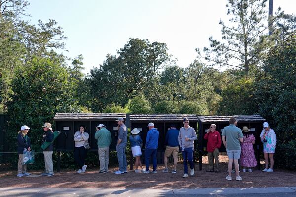 Patrons line up to use courtesy phones during a practice around at the Masters golf tournament, Wednesday, April 9, 2025, in Augusta, Ga. (AP Photo/Ashley Landis)