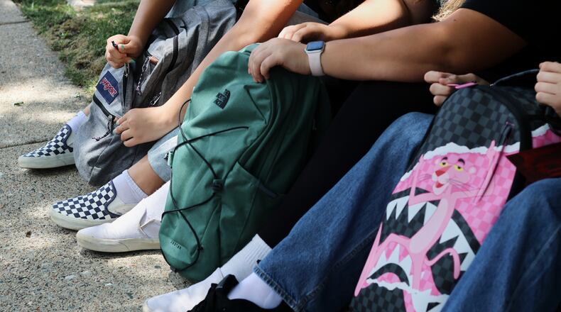 Middle school students Claire Knoth and Brockton Lozano and high school student Zoie Knoth share what is in their backpacks Friday, July 31, 2026, in Flagstaff, Ariz. (AP Photo/Cheyanne Mumphrey)