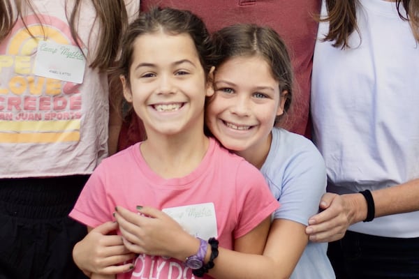 This undated photo provided by John Lawrence on Monday, July 7, 2025, shows twin sisters, Hanna Lawrence, left, and Rebecca Lawrence, right, who were two the victims killed by the flooding at Camp Mystic in central Texas on Friday, July 4. (John Lawrence via AP)