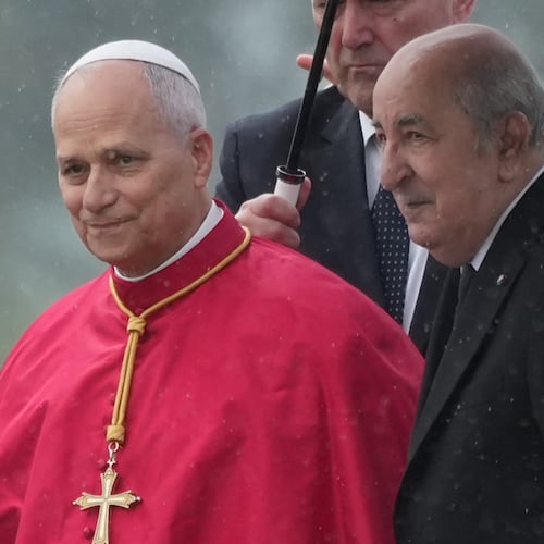 Pope Leo XIV is welcomed by Algerian President Abdelmadjid Tebboune, right, upon his arrival at Algiers' Houari Boumédiène International Airport on Monday, April 13, 2026, at the start of an 11-day apostolic journey to Africa. (AP Photo/Andrew Medichini)