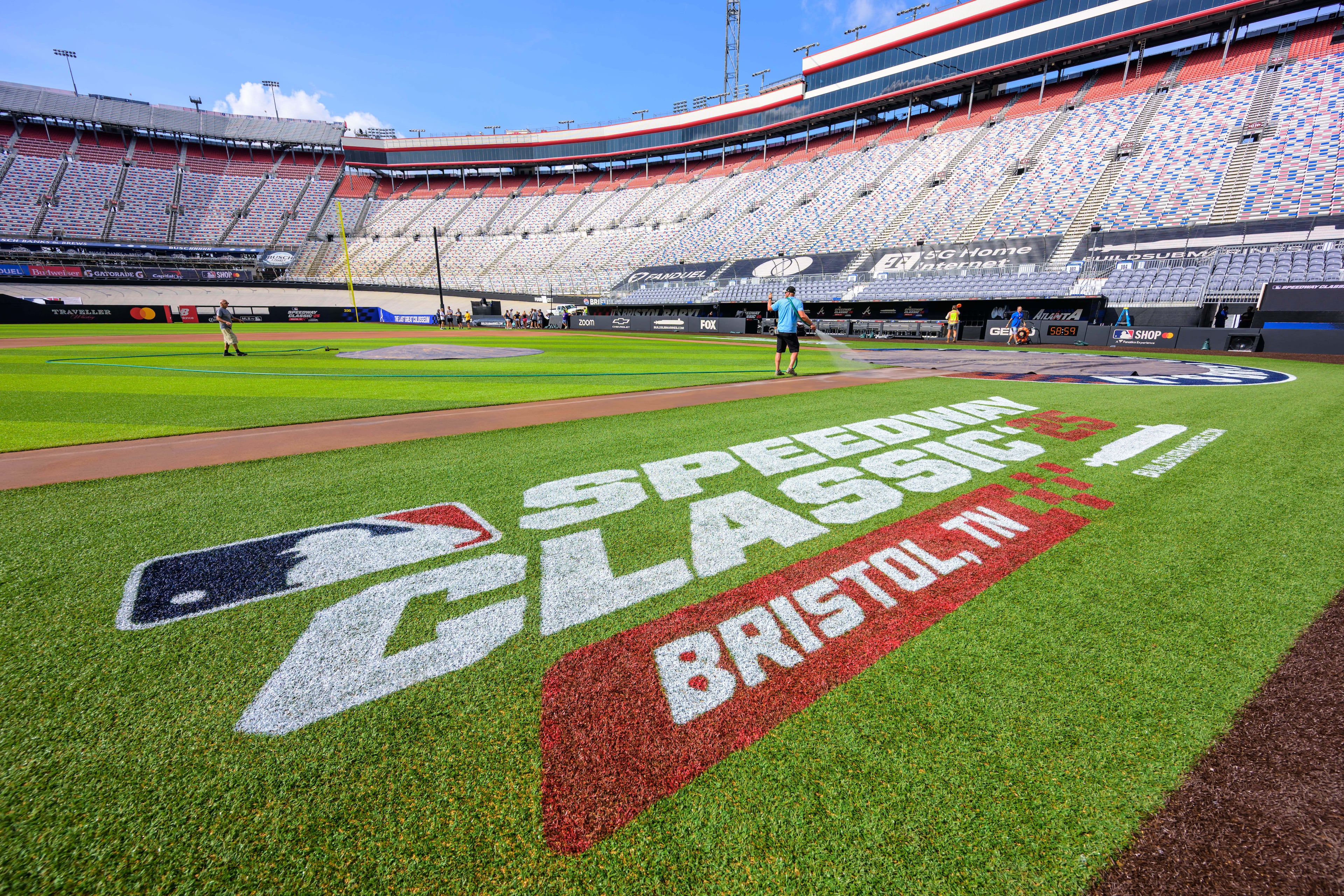 Grounds crew prepare the field inside the racetrack at Bristol Motor Speedway on Thursday, July 31, 2025, for the MLB Speedway Classic baseball game between the Cincinnati Reds and Atlanta Braves on Saturday in Bristol, Tenn. (Earl Neikirk/Bristol Motor Speedway via AP)