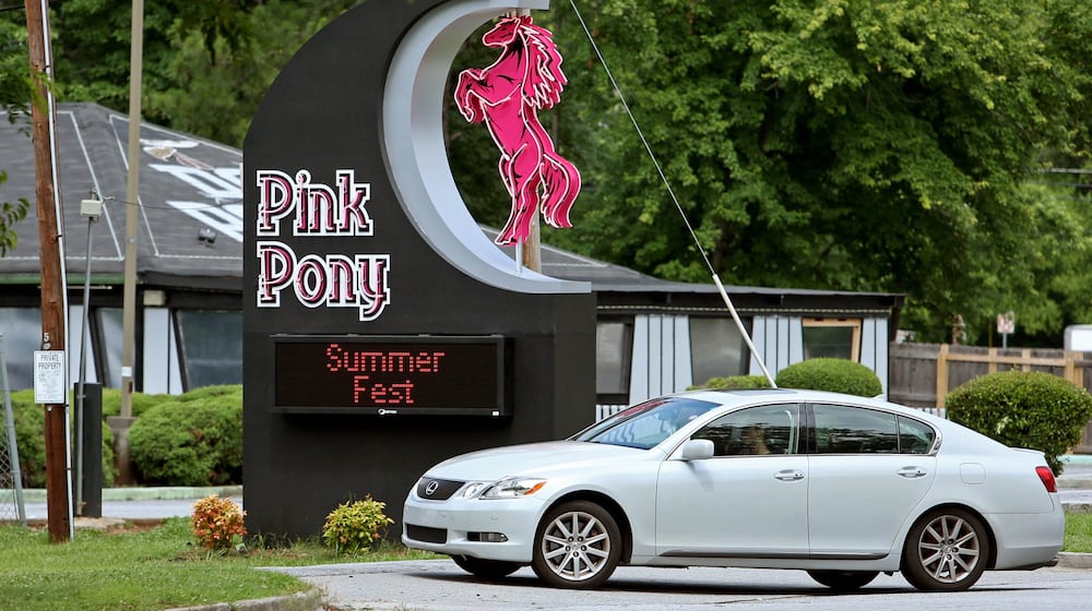 At the Pink Pony strip club, cold beer, shots and high balls tend to be the most popular beverages while customers watch nude women pole-dance. AJC FILE
