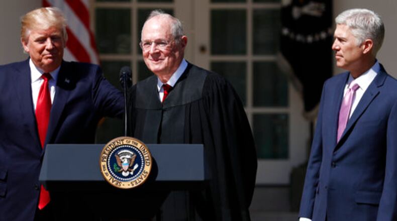 President Donald Trump, left, Supreme Court Justice Anthony Kennedy, center, and Justice Neil Gorsuch participate in a public swearing-in ceremony for Gorsuch in the Rose Garden of the White House White House in Washington, Monday, April 10, 2017. (AP Photo/Carolyn Kaster)