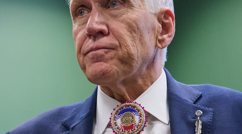 FILE - Wearing a beaded bolo around a pin that says "United States Senate," Sen. Thom Tillis, R-N.C., listens to thanks from members of the Lumbee Tribe of North Carolina, after the passage of a bill granting the tribe with federal recognition, on Capitol Hill, in Washington, Dec. 17, 2025. (AP Photo/Jacquelyn Martin, File)
