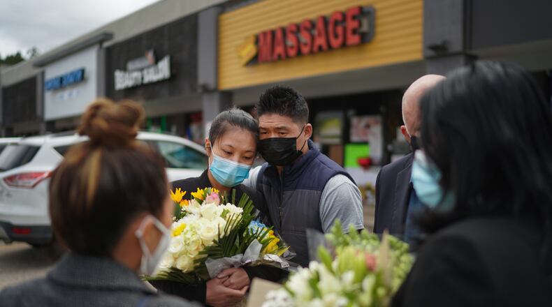 Jami Webb, the daughter of Xiaojie Tan, the owner of Young's Asian Massage who was killed in Tuesday's shootings, with her fiancé, Kevin Chen, outside the spa in Acworth, Ga., March 19, 2021. Tan died two days ahead of her 50th birthday. (Chang W. Lee/The New York Times)