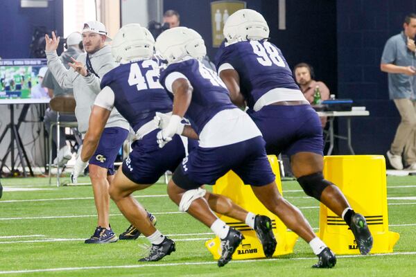 Georgia Tech defensive coordinator Jason Semore (left) leads a drill earlier this month. (Miguel Martinez/AJC)