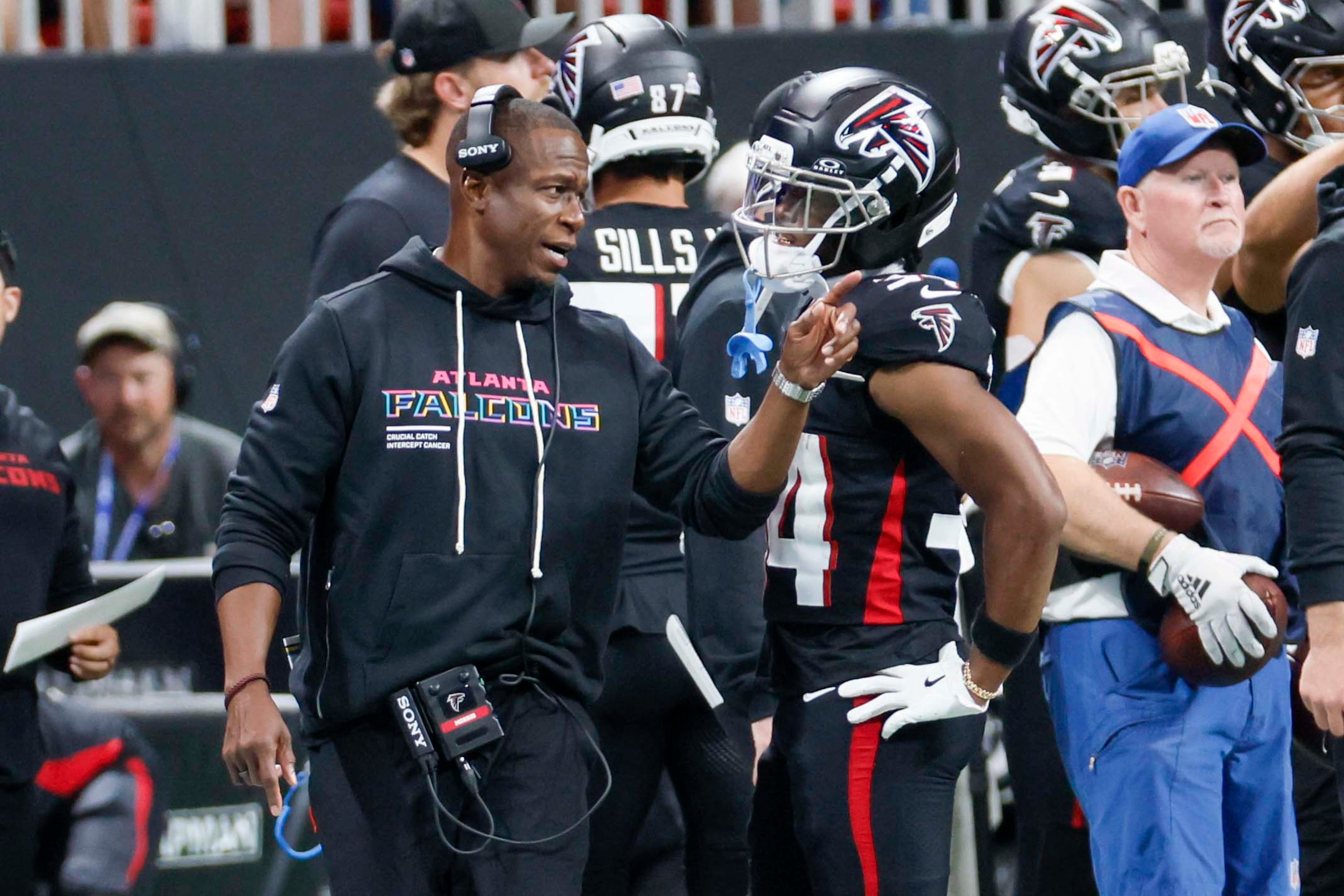 Falcons head coach Raheem Morris gives instructions to receiver Ray-Ray McCloud.
