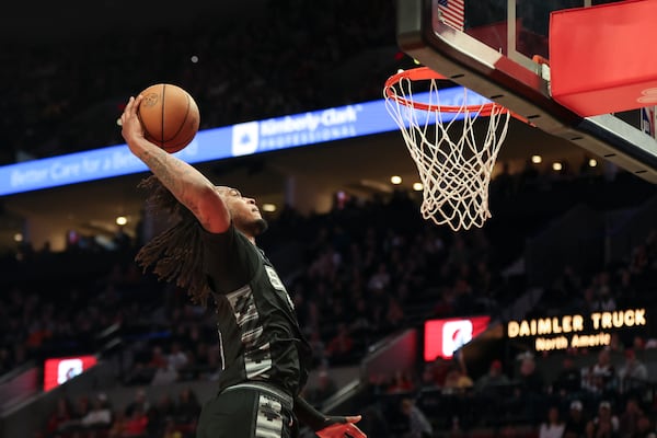 San Antonio Spurs guard Stephon Castle (5) dunks against the Portland Trail Blazers during the second half of an NBA basketball game Sunday, April 6, 2025, in Portland, Ore. (AP Photo/Amanda Loman)