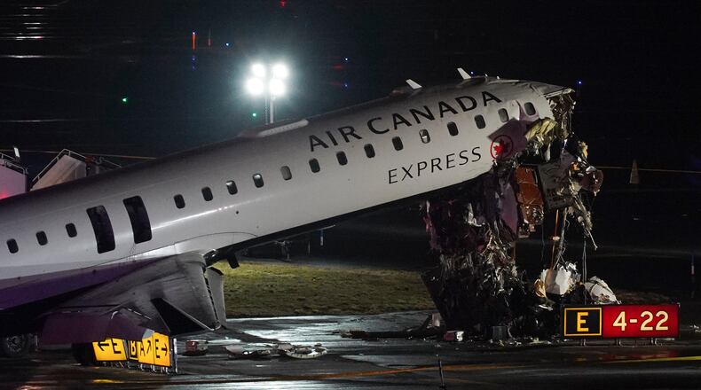 FILE - An Air Canada Jet sits on the runway at LaGuardia Airport, Monday, March 23, 2026, after colliding with a Port Authority aircraft rescue and firefighting vehicle after landing in New York. (AP Photo/Ryan Murphy, File)