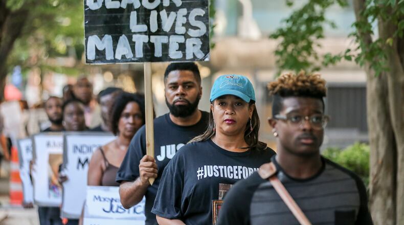 Protesters participate in a 24-hour rally outside the Fulton County Justice Center to bring attention to the number of black men killed by police on Wednesday, Aug. 31, 2016. JOHN SPINK /JSPINK@AJC.COM