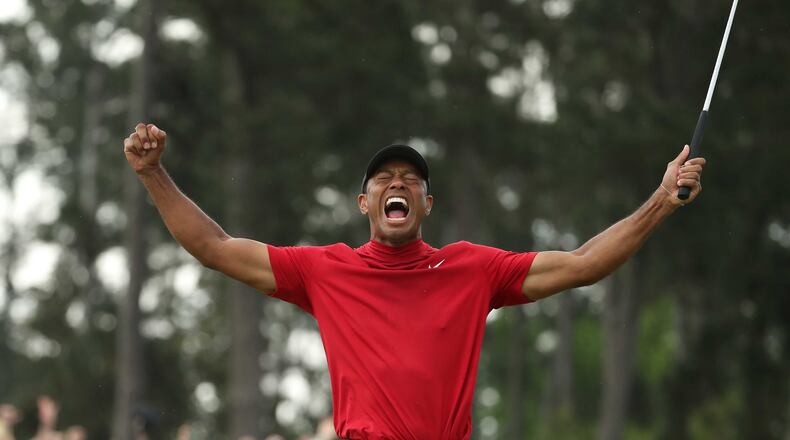 Tiger Woods celebrates winning the Masters during the final round Sunday, April 14, 2019, at Augusta National Golf Club in Augusta. (JASON GETZ/SPECIAL TO THE AJC)