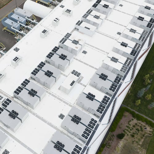 FILE - Fans, part of a cooling system, are visible on the roof of a data center April 27, 2026, in Hillsboro, Ore. (AP Photo/Jenny Kane, File)