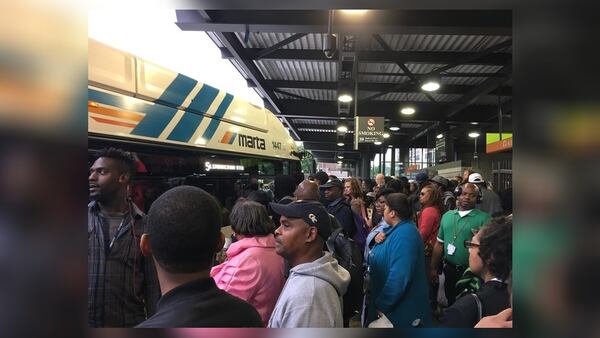 MARTA passengers at the Lindbergh station wait on buses to take them to the nearest station after a fire broke out on the transit system's tracks. SUSAN POTTER / SPOTTER@AJC.COM
