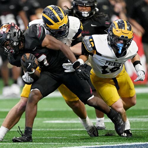 Hebron Christian running back Devon Caldwell maneuvers past Prince Avenue Christian's Mac Bradley for a first down during last year's championship game. The two face off again Friday night. (Hyosub Shin/AJC)