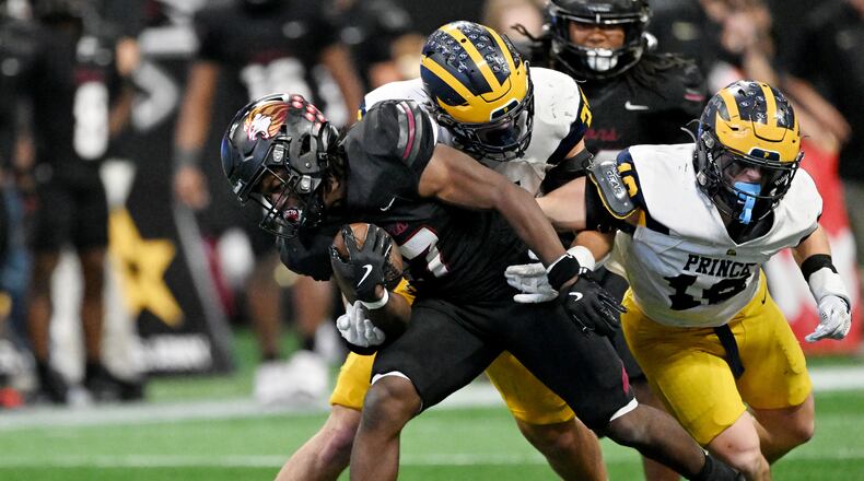 Hebron Christian running back Devon Caldwell maneuvers past Prince Avenue Christian's Mac Bradley for a first down during last year's championship game. The two face off again Friday night. (Hyosub Shin/AJC)